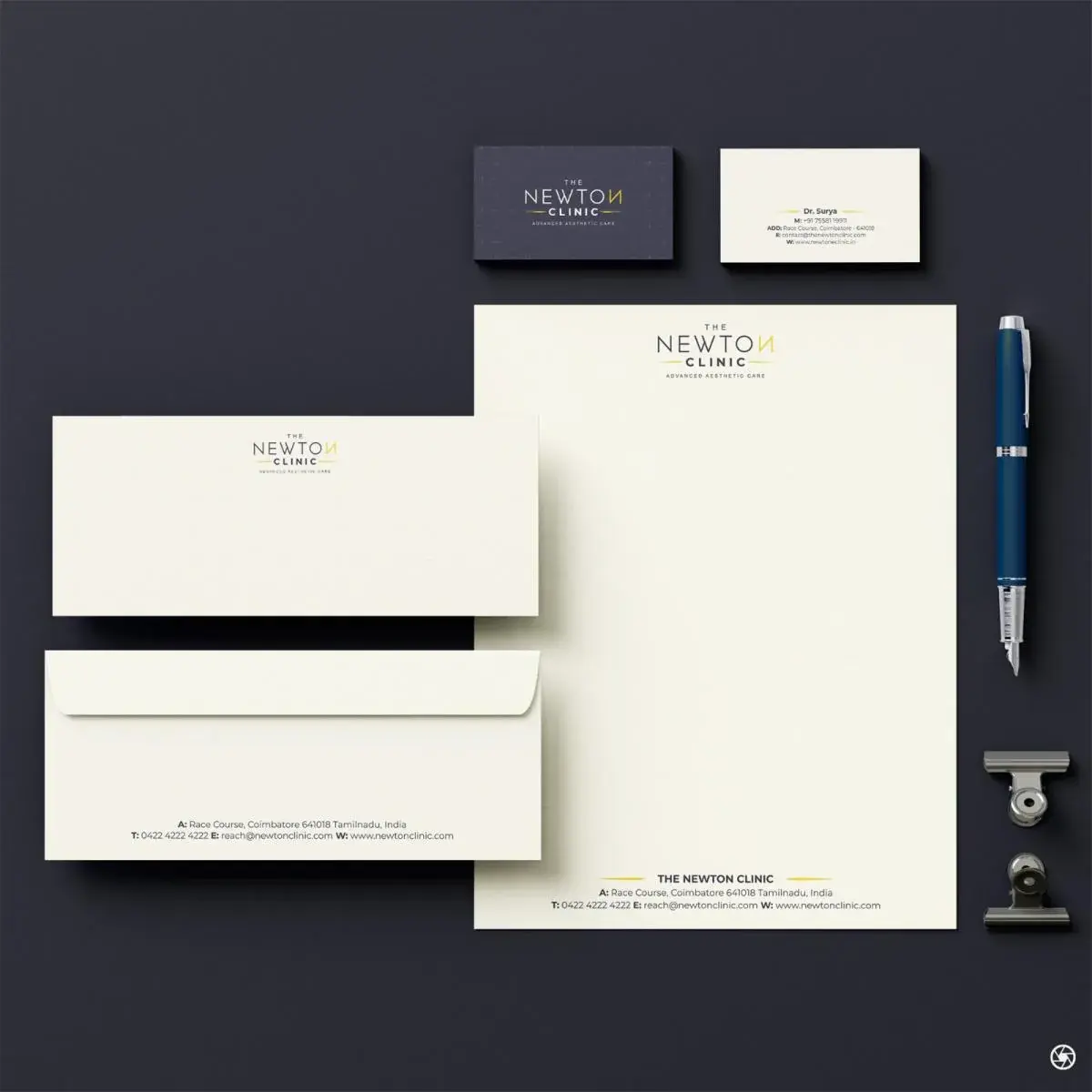 The Newton Clinic stationery system: business cards, letterhead, and envelopes on navy