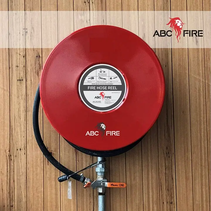ABC Fire - branded Fire Hose Reel installed on a wall, red disc with ABC Fire label and instructions