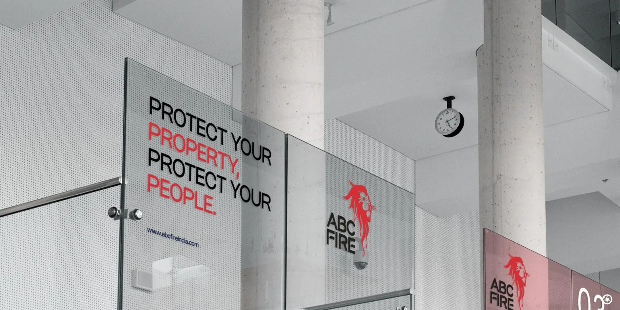 ABC Fire - office glass partition with the campaign headline frosted in red and black and the lion mark on the adjoining panel