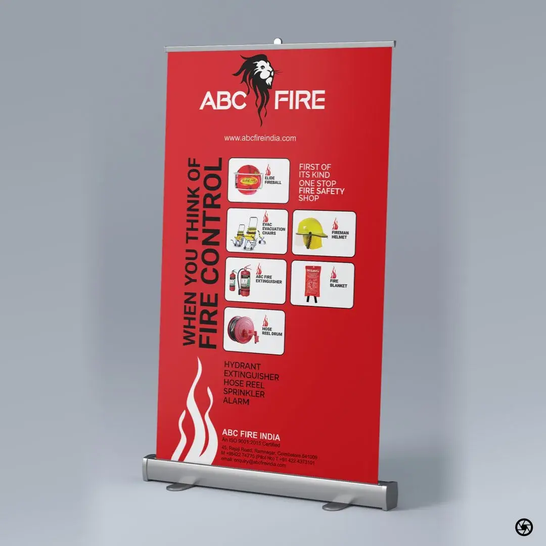 ABC Fire - full-red rollup standee, 'WHEN YOU THINK OF FIRE CONTROL' headline alongside thumbnails of Elide fireball, evacuation chairs, fireman helmet, extinguisher, fire blanket, and hose reel drum