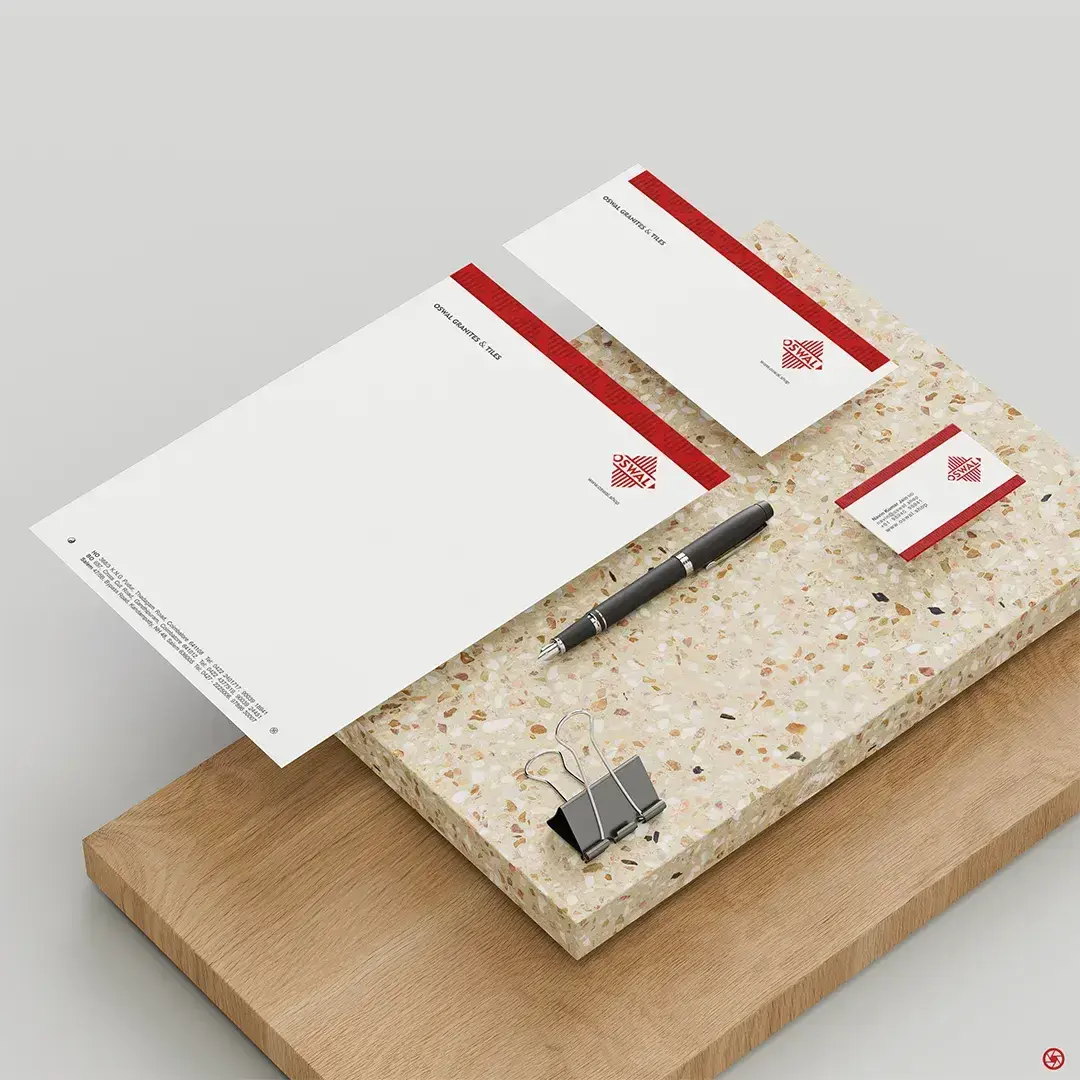 Oswal Granites & Tiles - letterhead and business cards styled on a granite and wood surface