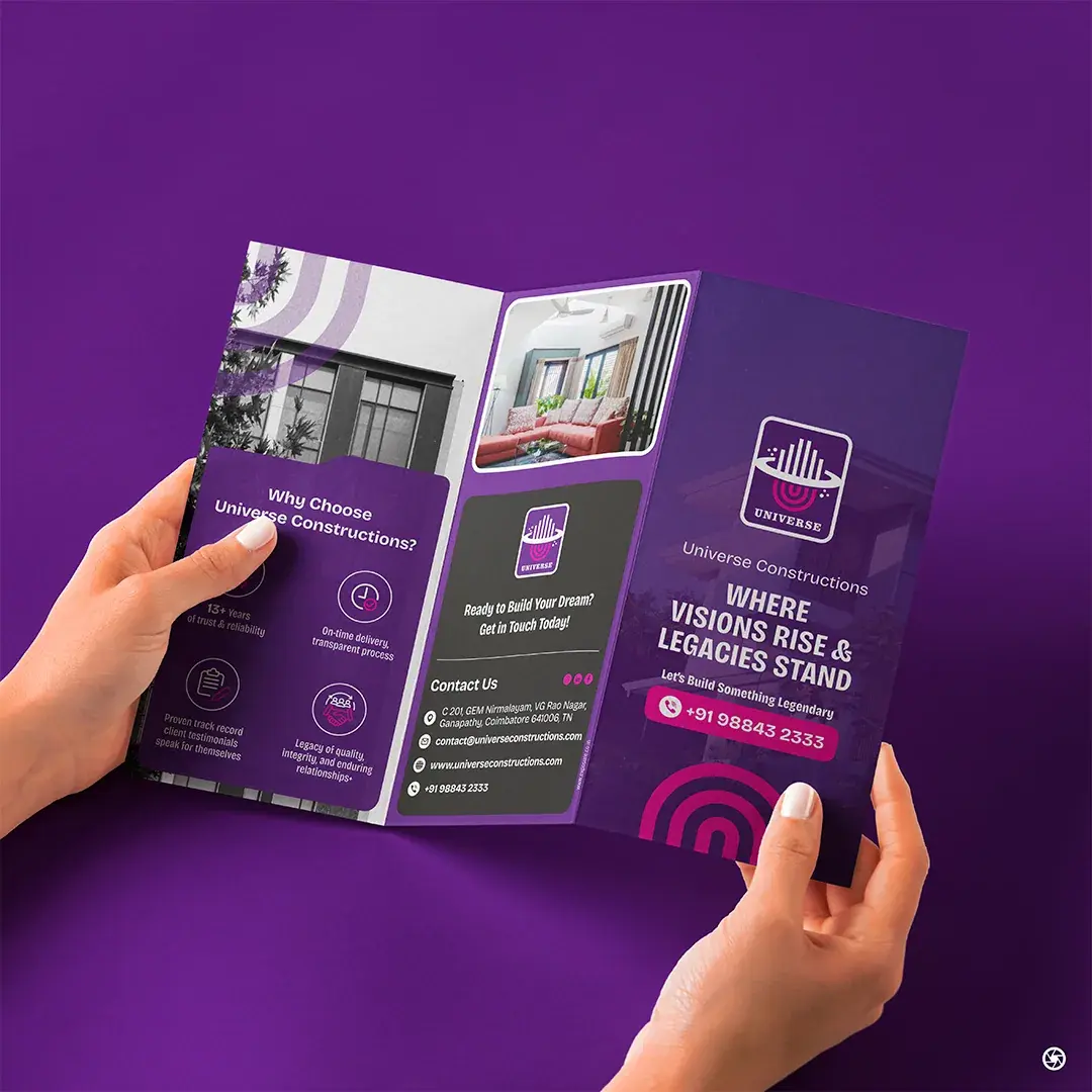 Universe Constructions - brochure held in a presenter's hand, opened to the services panel
