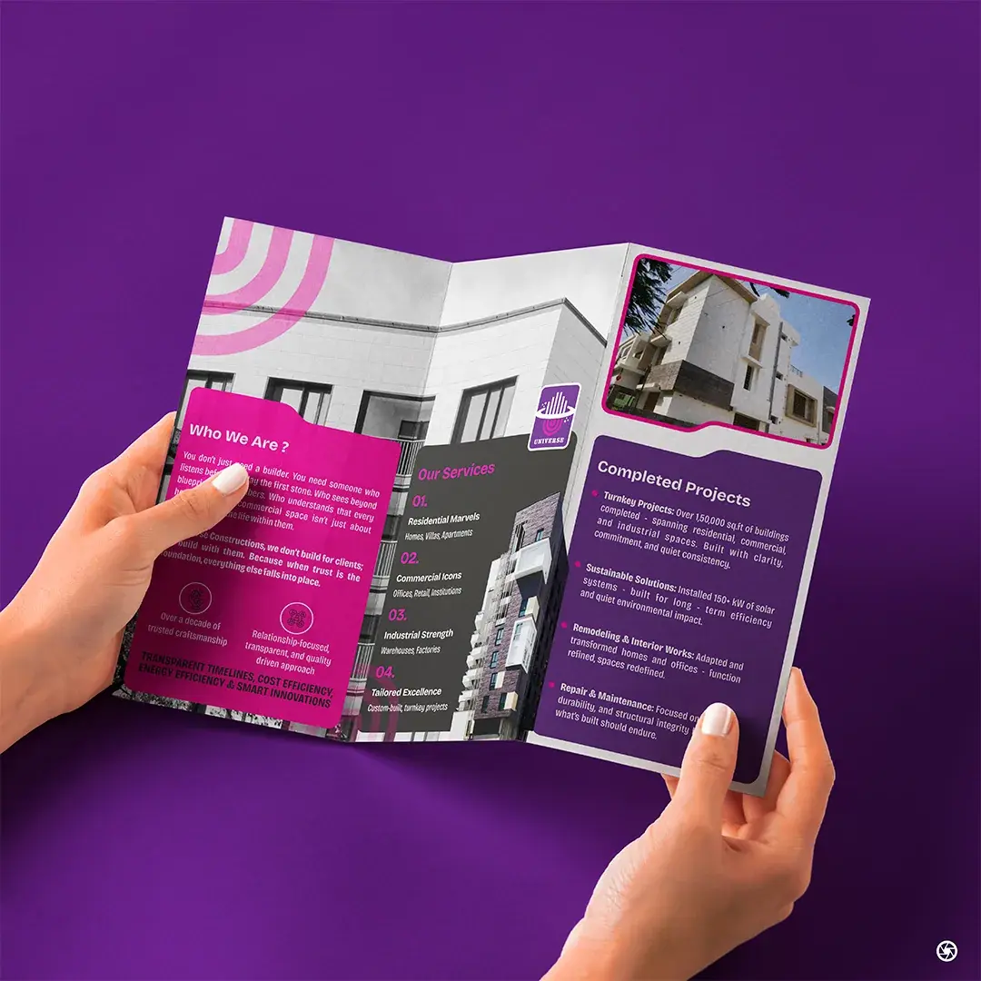 Universe Constructions - brochure shown in-hand from a second angle, cover facing the camera